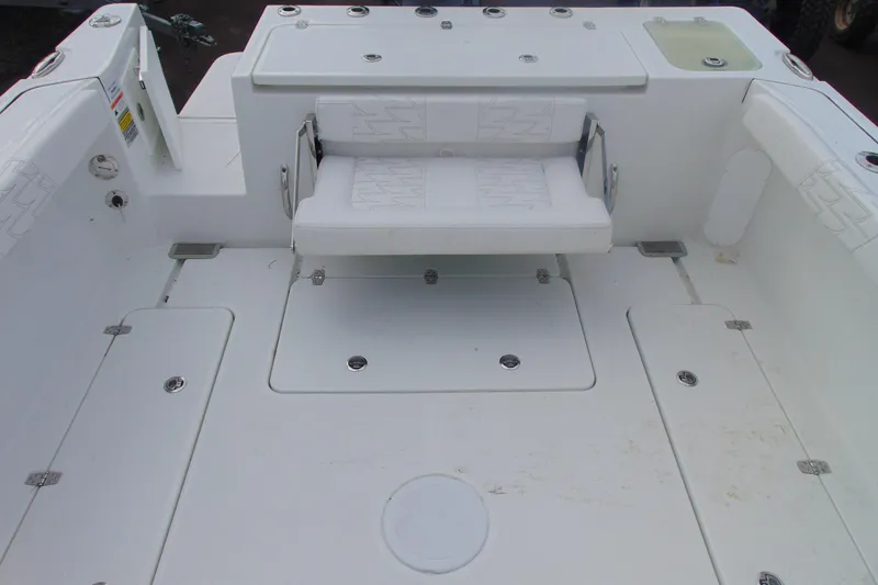Slide: The Image of 2026 Parker 247 Explorer boat interior with white seating and storage compartments. - 8