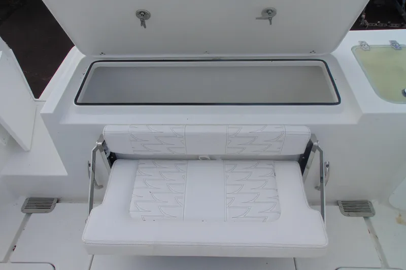 Slide: The Image of 2026 Parker 247 Explorer boat seat with storage compartment open. - 9