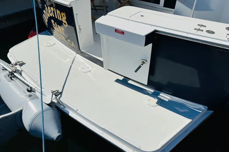 Slide: The Image of 2000 Mainship 390 Trawler stern with swim platform and attached inflatable dinghy. - 12