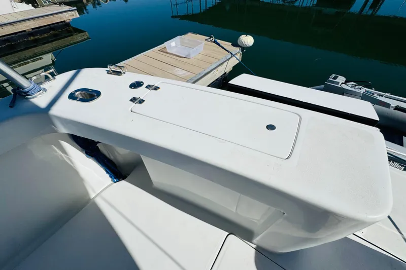 Slide: The Image of 2000 Mainship 390 Trawler deck with storage compartment and dock view. - 14