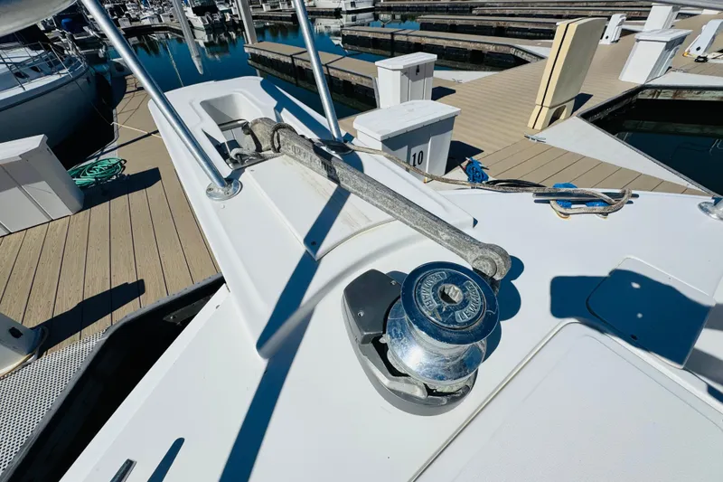 Slide: The Image of Bow of 2000 Mainship 390 Trawler with anchor and winch at marina. - 19