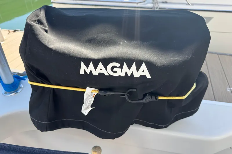 Slide: The Image of Black Magma grill cover on a 2000 Mainship 390 Trawler boat deck. - 23