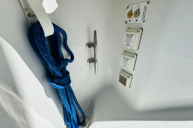 Slide: The Image of Blue rope and power outlets on 2000 Mainship 390 Trawler boat. - 24