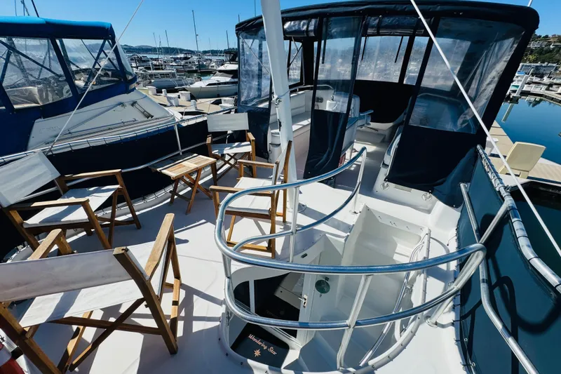 Slide: The Image of 2000 Mainship 390 Trawler deck with seating, docked at marina. - 27