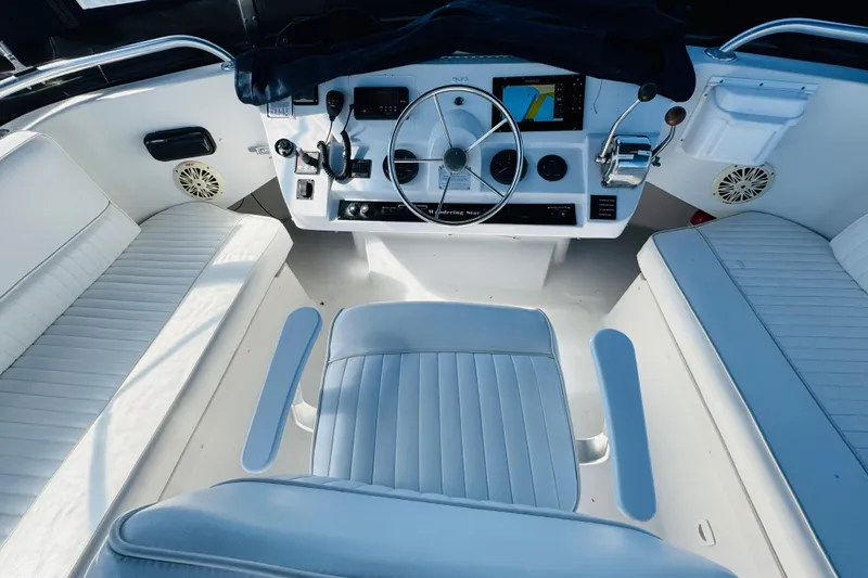 Slide: The Image of Helm of 2000 Mainship 390 Trawler with white seating and navigation equipment. - 31