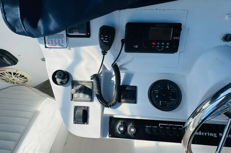 Slide: The Image of Control panel of a 2000 Mainship 390 Trawler with radio and navigation instruments. - 34