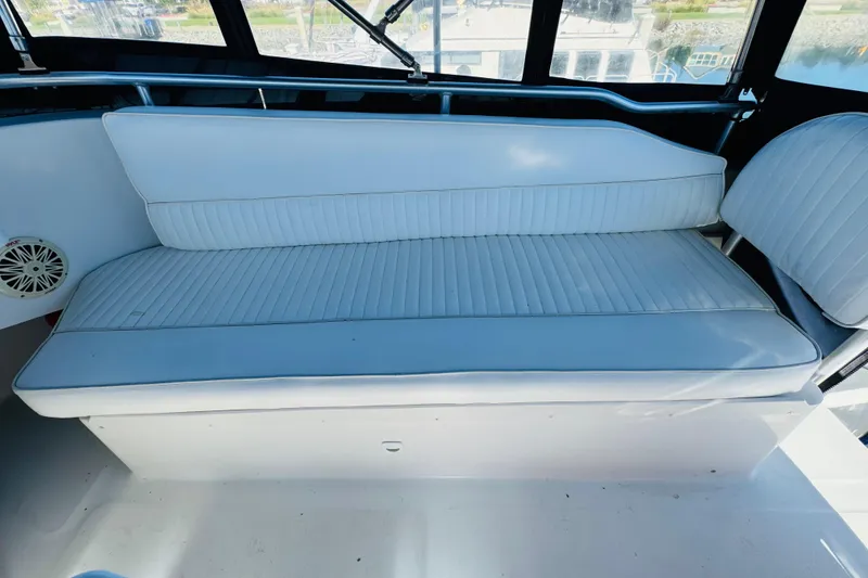 Slide: The Image of White cushioned seating on 2000 Mainship 390 Trawler boat, featuring sleek design and comfort. - 38