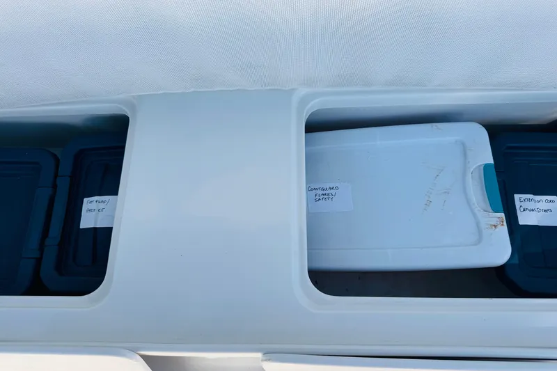 Slide: The Image of Storage compartments on a 2000 Mainship 390 Trawler with labeled safety and utility kits. - 39
