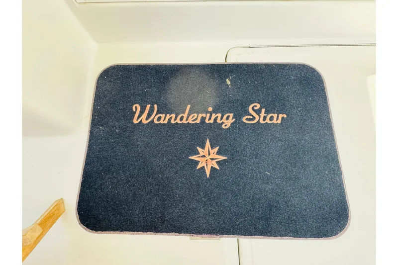 Slide: The Image of Floor mat with "Wandering Star" text on a 2000 Mainship 390 Trawler. - 40