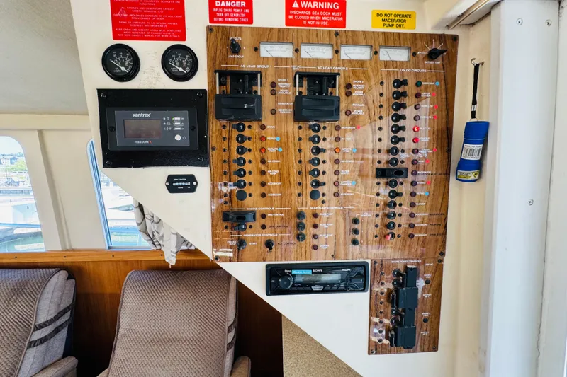 Slide: The Image of Control panel of a 2000 Mainship 390 Trawler with gauges and switches. - 60