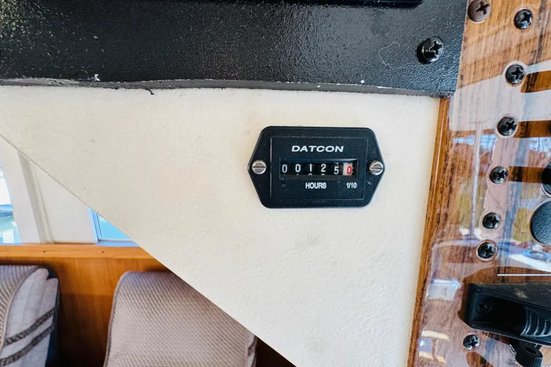 Slide: The Image of Hour meter reading 1250 on 2000 Mainship 390 Trawler dashboard. - 61