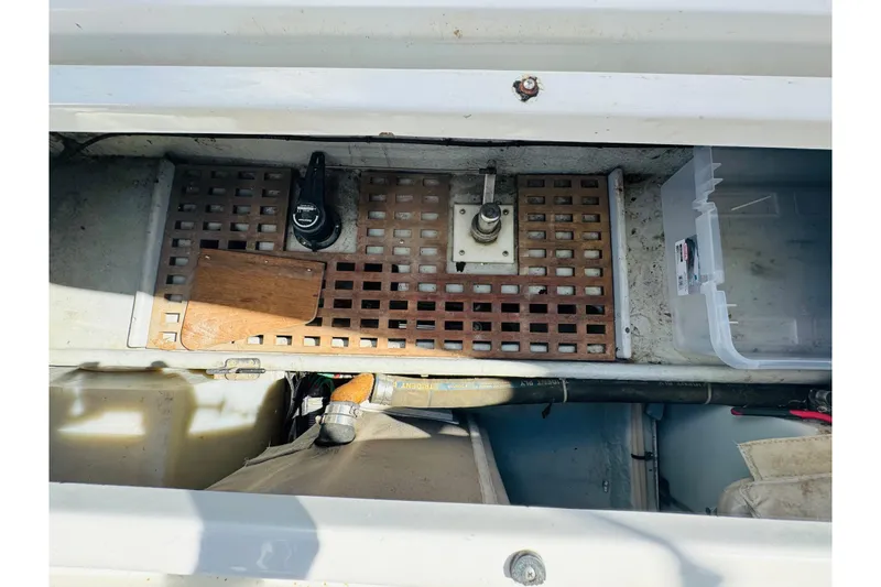Slide: The Image of 2000 Mainship 390 Trawler engine compartment with wooden grate and storage box. - 77