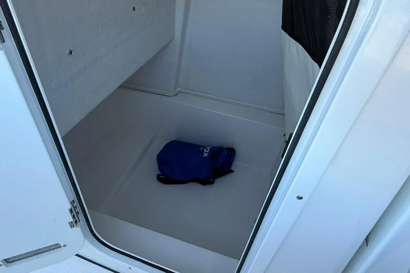 Slide: The Image of Storage compartment in 2026 Sea Fox 228 Commander boat with a blue bag inside. - 15