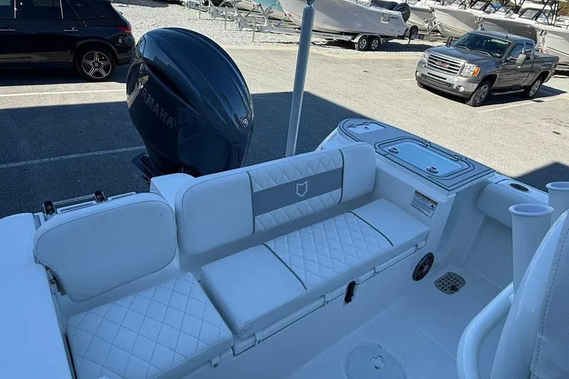 Slide: The Image of 2026 Sea Fox 228 Commander boat interior with Yamaha engine, featuring white cushioned seating. - 16
