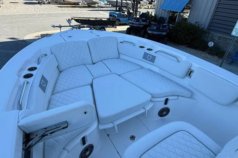 Slide: The Image of 2026 Sea Fox 228 Commander boat with white cushioned seating and cup holders. - 18