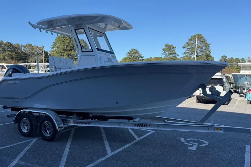 Slide: The Image of 2026 Sea Fox 228 Commander boat on trailer in parking lot. - 2