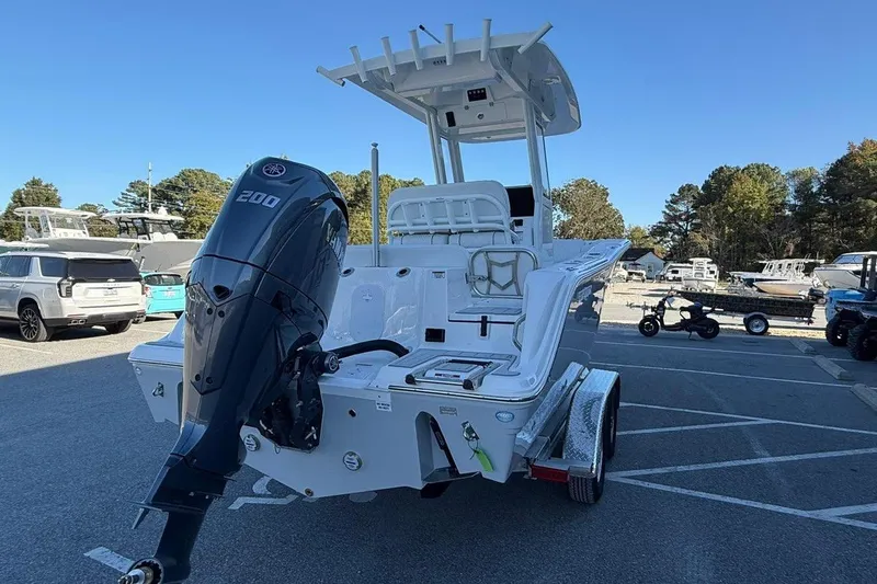 Slide: The Image of 2026 Sea Fox 228 Commander boat with outboard motor in a parking lot. - 3