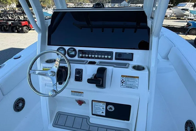 Slide: The Image of 2026 Sea Fox 228 Commander boat dashboard with steering wheel and controls. - 8