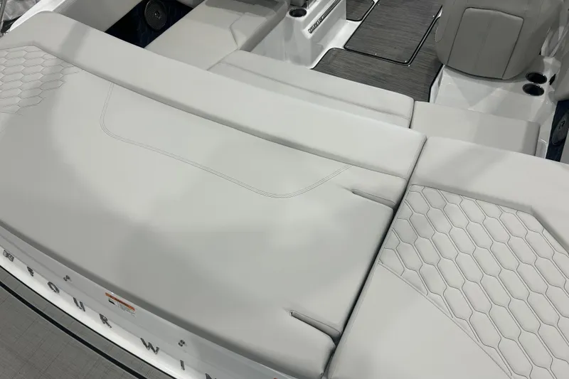 Slide: The Image of 2026 Four Winns H1 Freedom boat interior with sleek, modern seating and hexagonal patterns. - 10