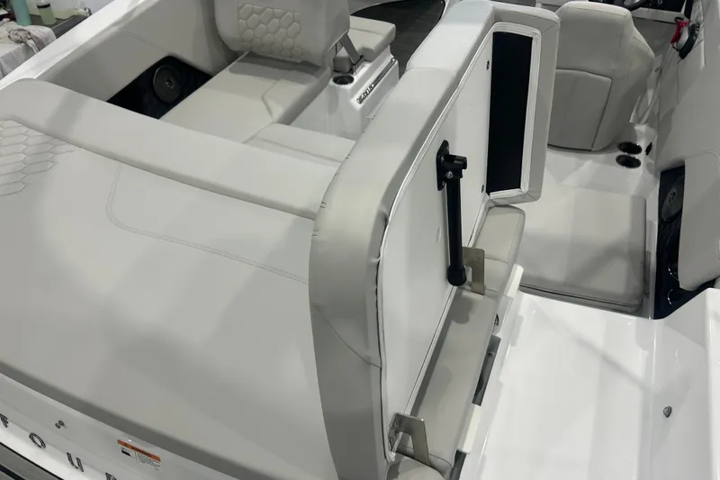 Slide: The Image of 2026 Four Winns H1 Freedom boat interior with sleek white seating and modern design. - 12