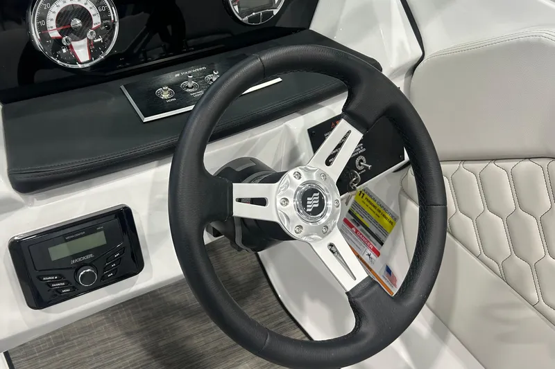 Slide: The Image of Steering wheel and dashboard of 2026 Four Winns H1 Freedom boat, featuring modern controls. - 18