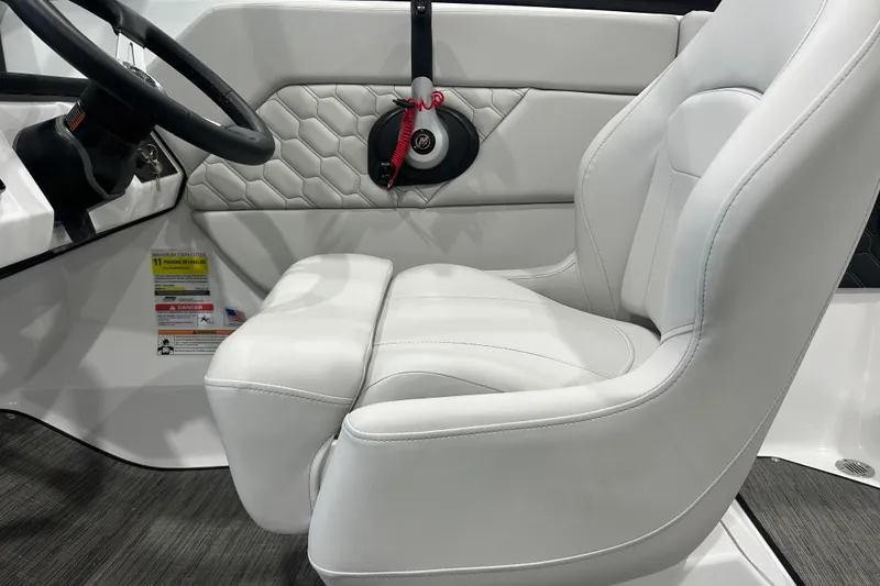 Slide: The Image of 2026 Four Winns H1 Freedom boat interior with white leather seating and steering wheel. - 20