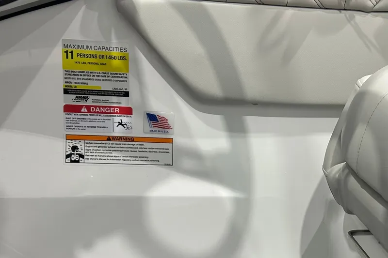 Slide: The Image of 2026 Four Winns H1 Freedom boat capacity and safety warning labels. - 21