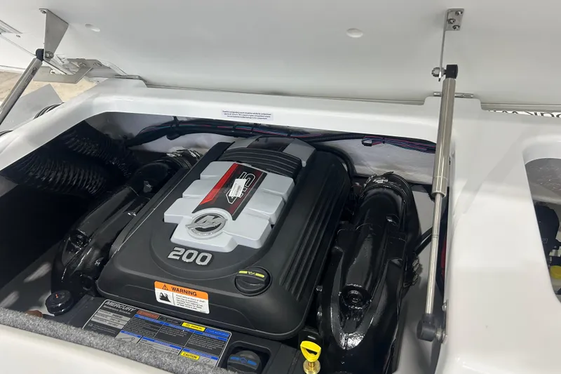 Slide: The Image of 2026 Four Winns H1 Freedom boat engine compartment with Mercury 200 horsepower engine. - 28