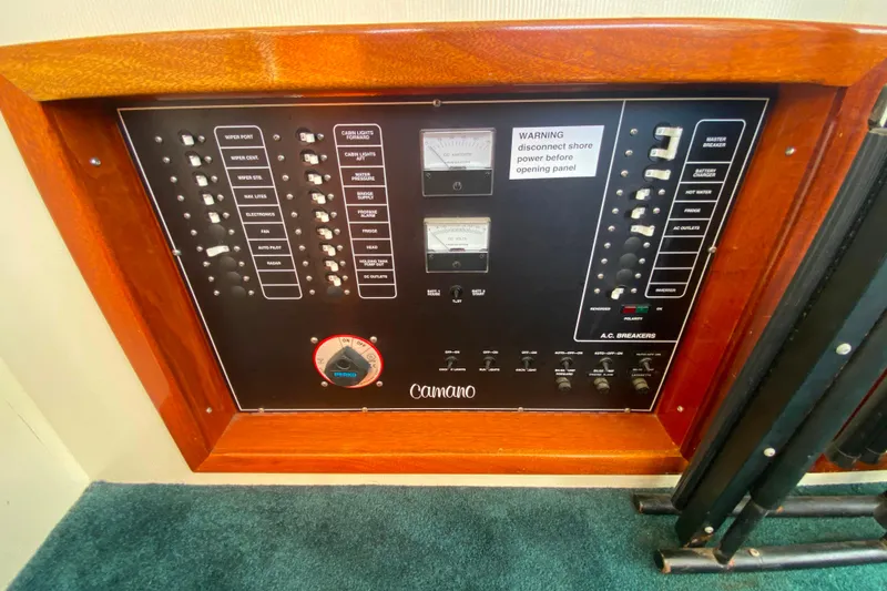 Slide: The Image of Electrical control panel on a Camano 30 boat with various switches and meters. - 14
