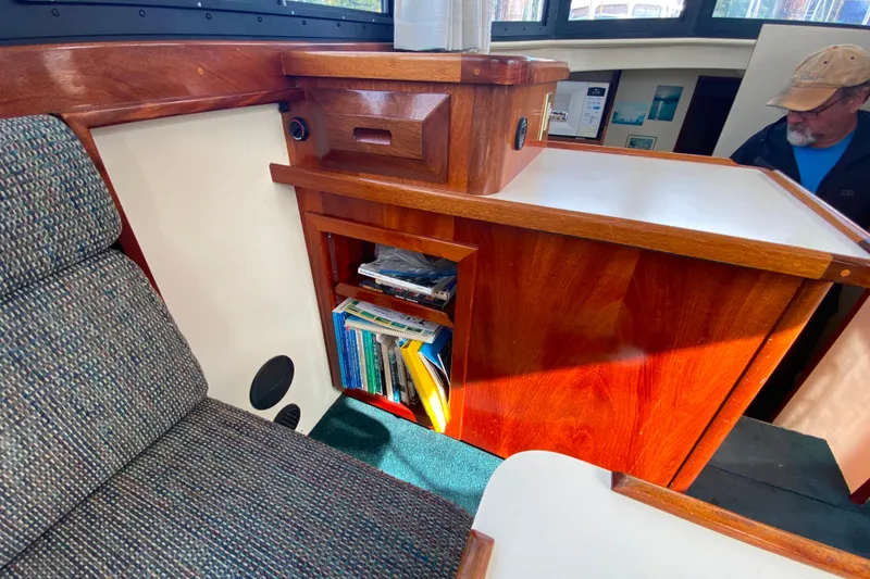 Slide: The Image of Interior of Camano 30 boat with wooden cabinetry and bookshelves. - 15