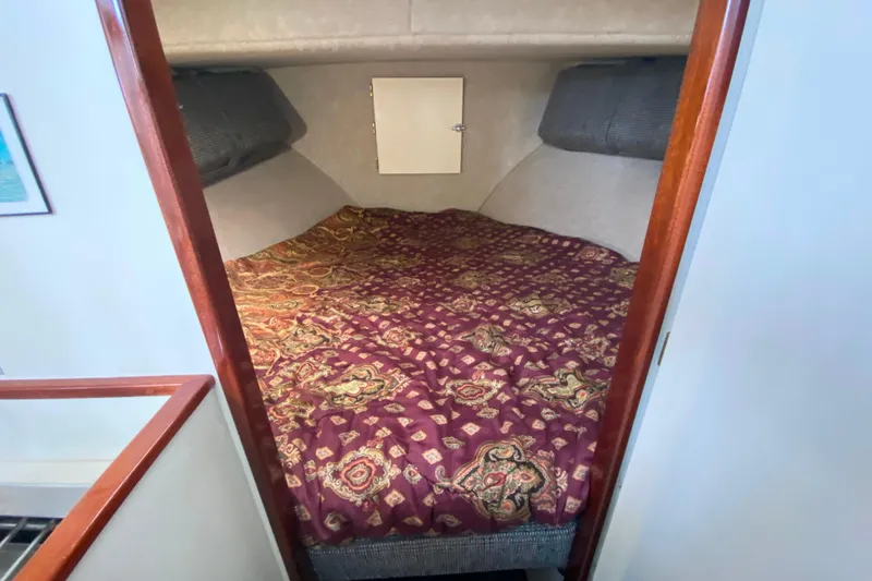 Slide: The Image of Cozy sleeping area in Camano 30 boat with patterned bedding. - 21