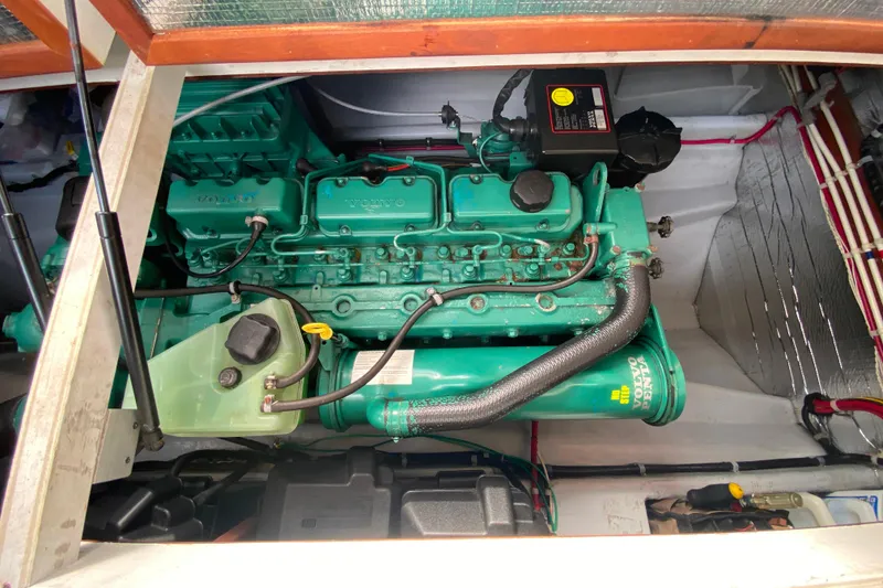 Slide: The Image of Engine compartment of a Camano 30 boat featuring a green Volvo Penta engine. - 28