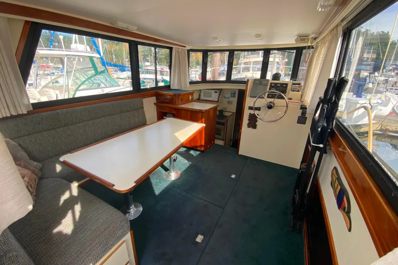 Slide: The Image of Interior of Camano 30 boat with seating, table, and helm station. - 3
