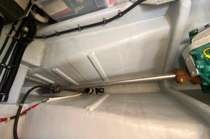 Slide: The Image of Camano 30 boat engine compartment with visible shaft and wiring. - 30