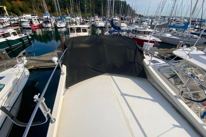 Slide: The Image of Camano 30 boat docked in a marina surrounded by other vessels. - 33
