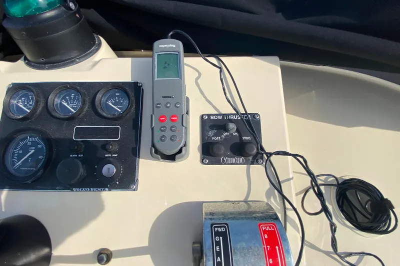 Slide: The Image of Camano 30 boat dashboard with gauges, bow thruster controls, and remote device. - 38