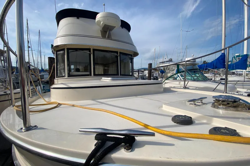 Slide: The Image of Camano 30 boat docked at marina, showcasing deck and cabin area. - 45