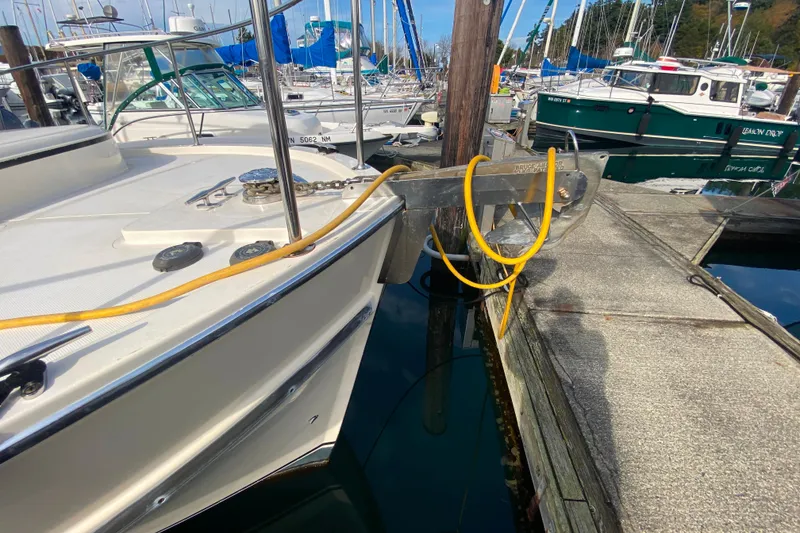 Slide: The Image of Camano 30 boat docked at marina with yellow hose and anchor chain visible. - 46
