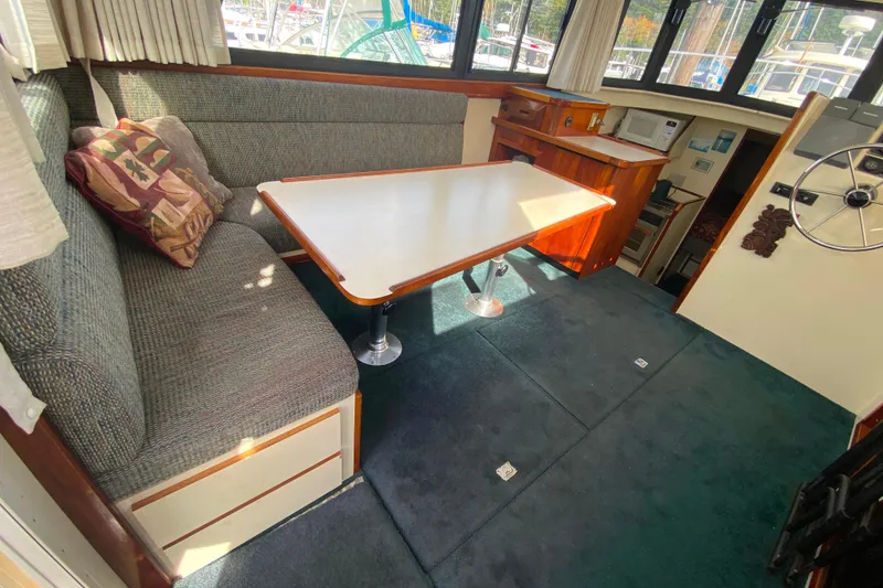 Slide: The Image of Interior of Camano 30 boat with dining area and helm station. - 6