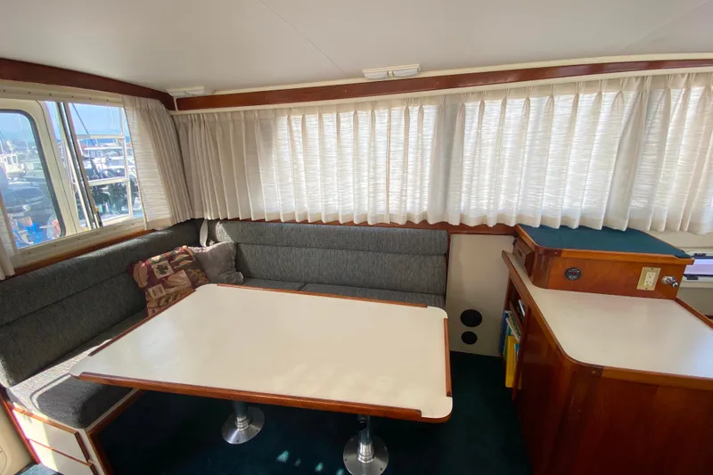 Slide: The Image of Cozy interior of Camano 30 boat with dining area and large windows. - 7