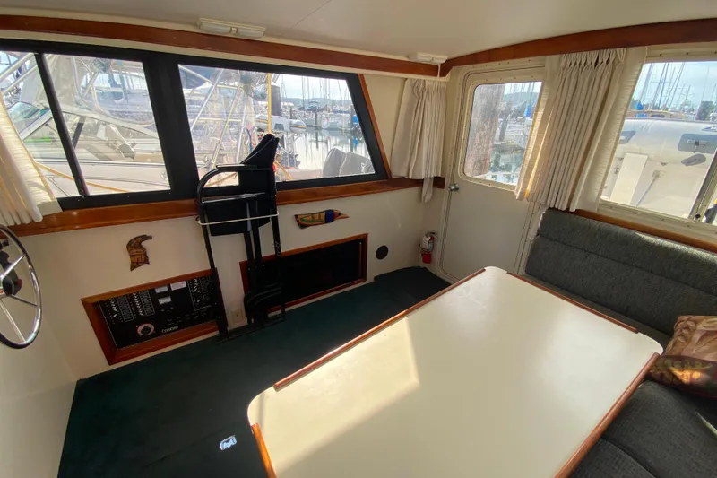 Slide: The Image of Interior of Camano 30 boat with seating, table, and large windows. - 8