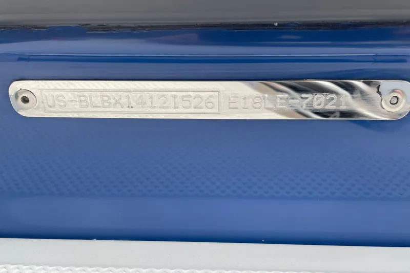 Slide: The Image of 2026 Bayliner Element E18 boat identification plate on blue hull. - 11