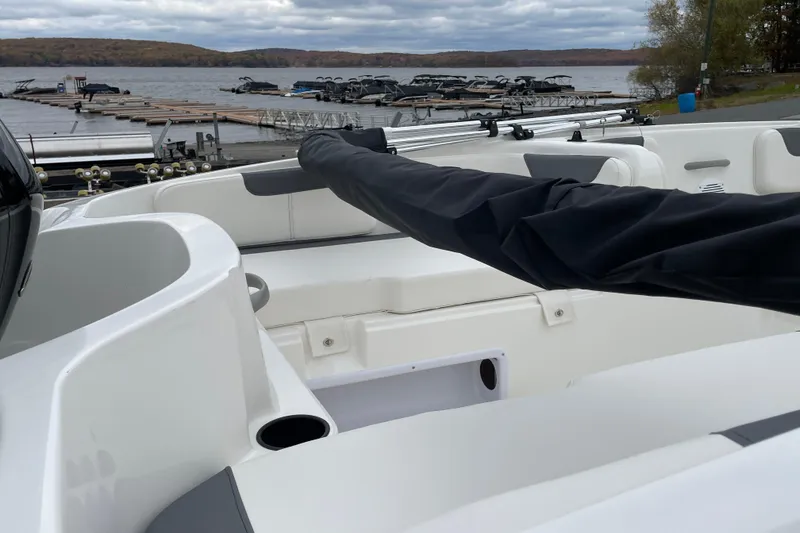Slide: The Image of 2026 Bayliner Element E18 boat interior at a lakeside dock. - 6