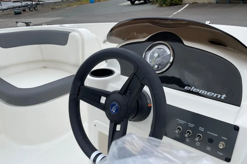Slide: The Image of 2026 Bayliner Element E18 boat dashboard with steering wheel and control panel. - 7