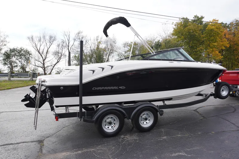 Slide: The Image of 2026 Chaparral 21 SSi Ski & Fish boat on trailer, parked outdoors. - 1