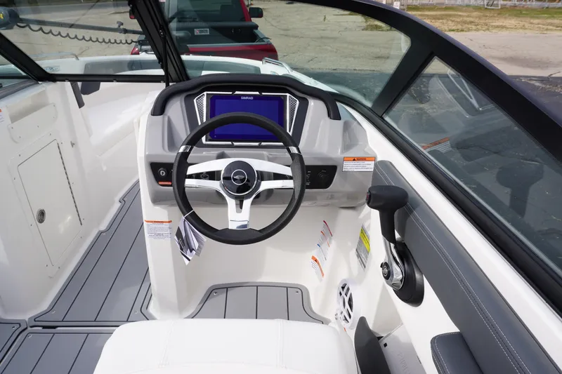Slide: The Image of 2026 Chaparral 21 SSi Ski & Fish boat cockpit with steering wheel and control panel. - 10