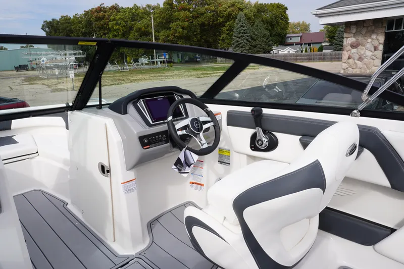 Slide: The Image of 2026 Chaparral 21 SSi Ski & Fish boat interior with steering wheel and controls. - 11