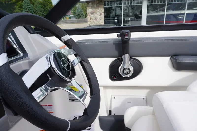 Slide: The Image of 2026 Chaparral 21 SSi Ski & Fish boat interior with steering wheel and throttle control. - 15