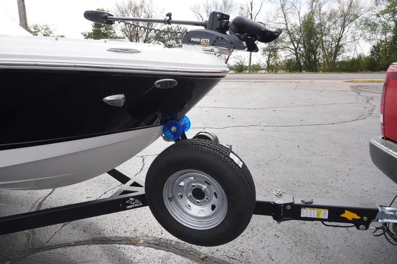 Slide: The Image of 2026 Chaparral 21 SSi Ski & Fish boat on trailer, parked outdoors. - 3