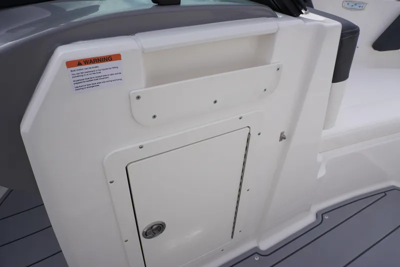 Slide: The Image of 2026 Chaparral 21 SSi Ski & Fish boat interior storage compartment with warning label. - 38